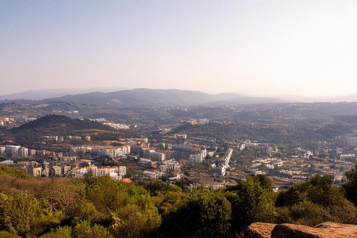 Hilltop view Cityscape panorama, mountain backdrop photo