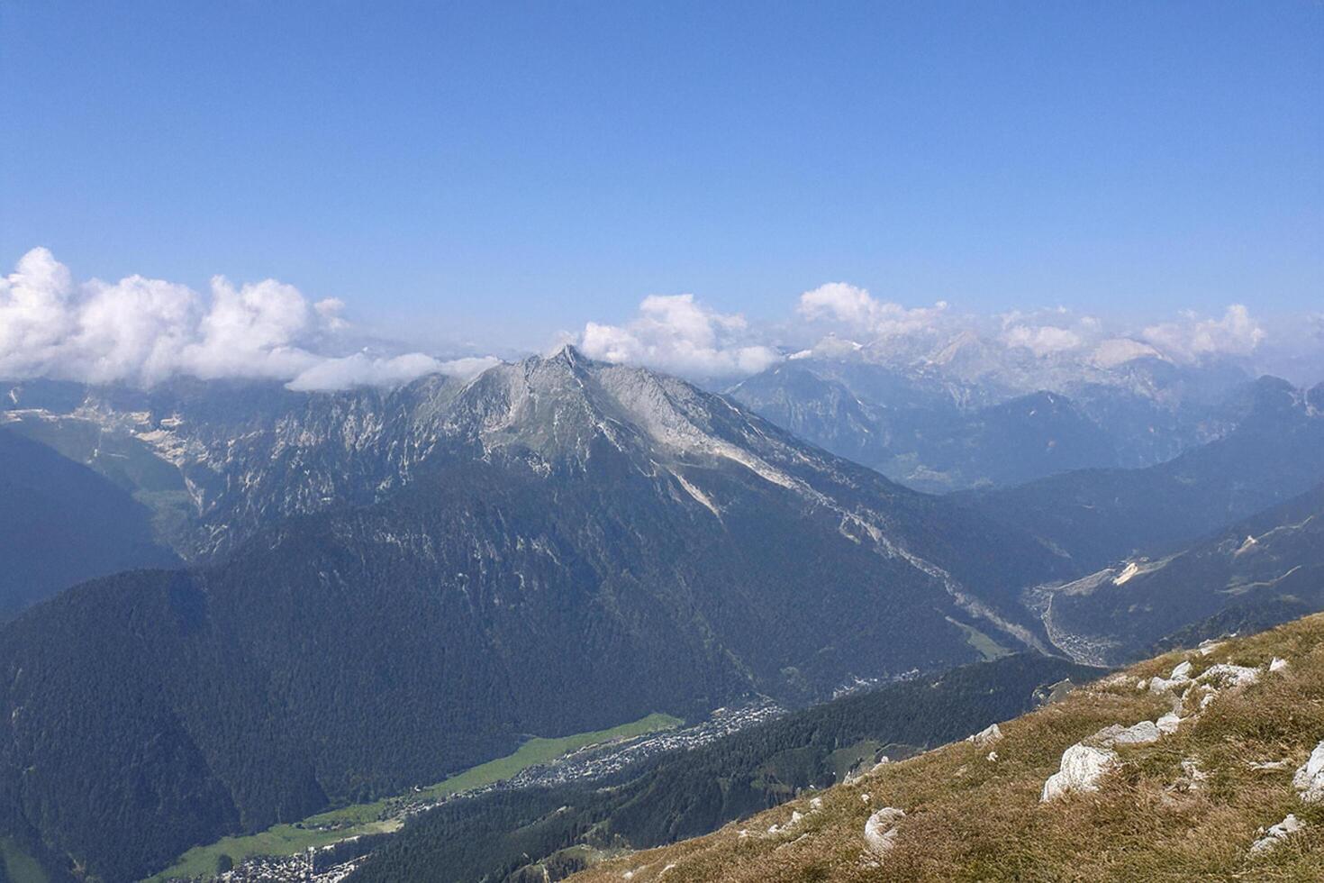 Alpine panorama mountain peak, valley view, clouds, summer photo