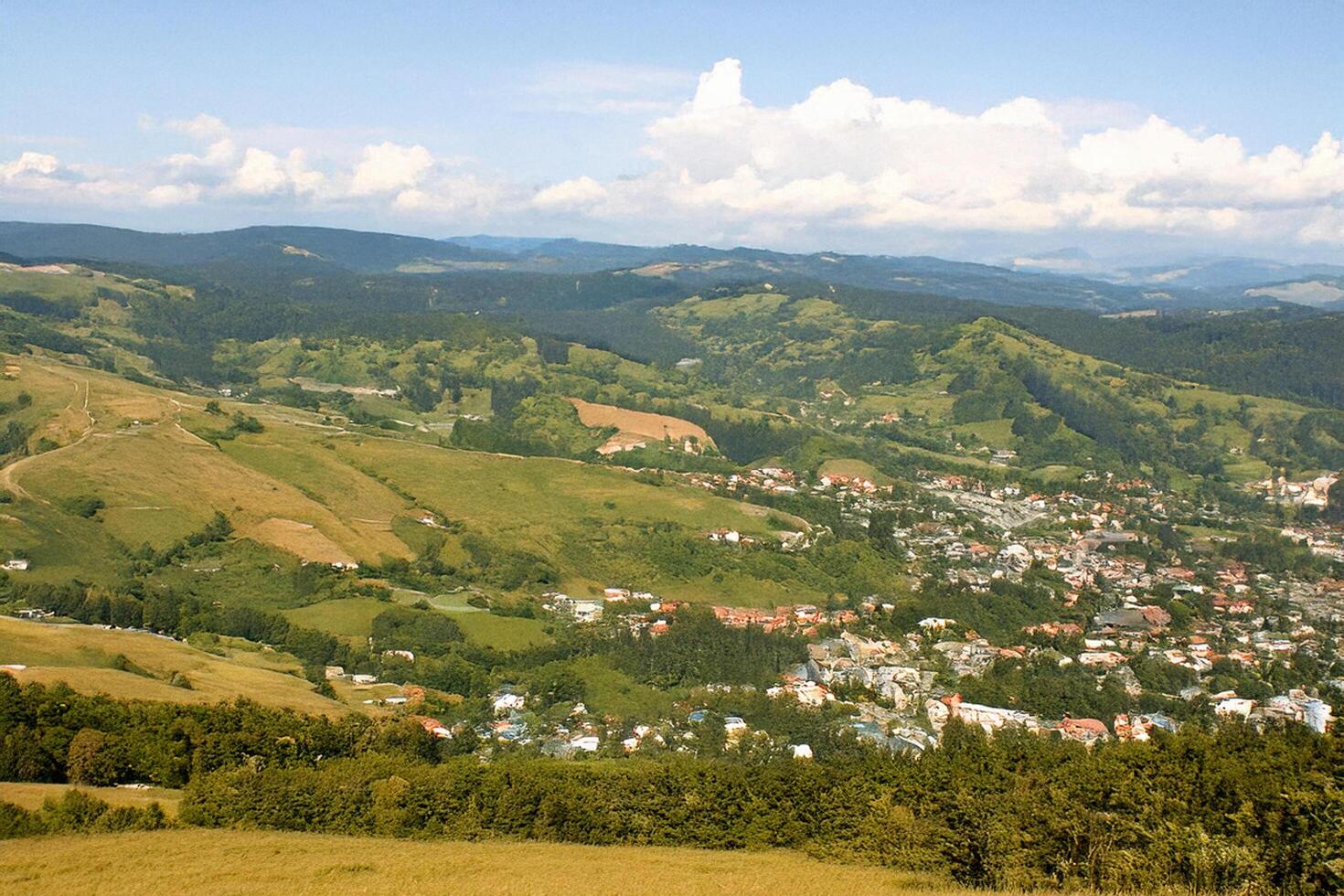 Mountaintop view town, hills, summer sky, travel brochure photo