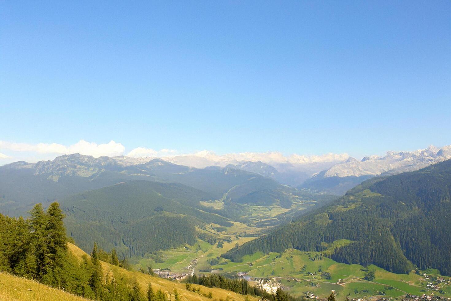 Mountain valley panorama, summer, clear sky, village below photo