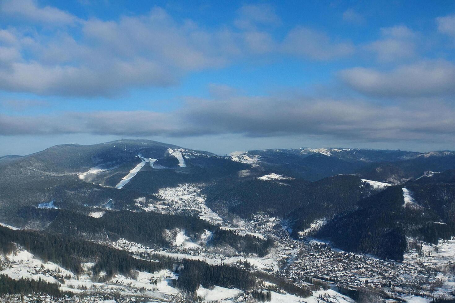 Snowy mountain valley aerial view, winter landscape, ski resort photo