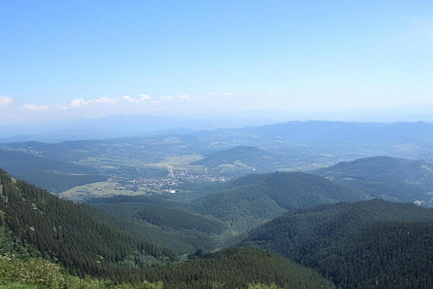 Mountaintop view valley, town, clear sky, distant hills, travel photo