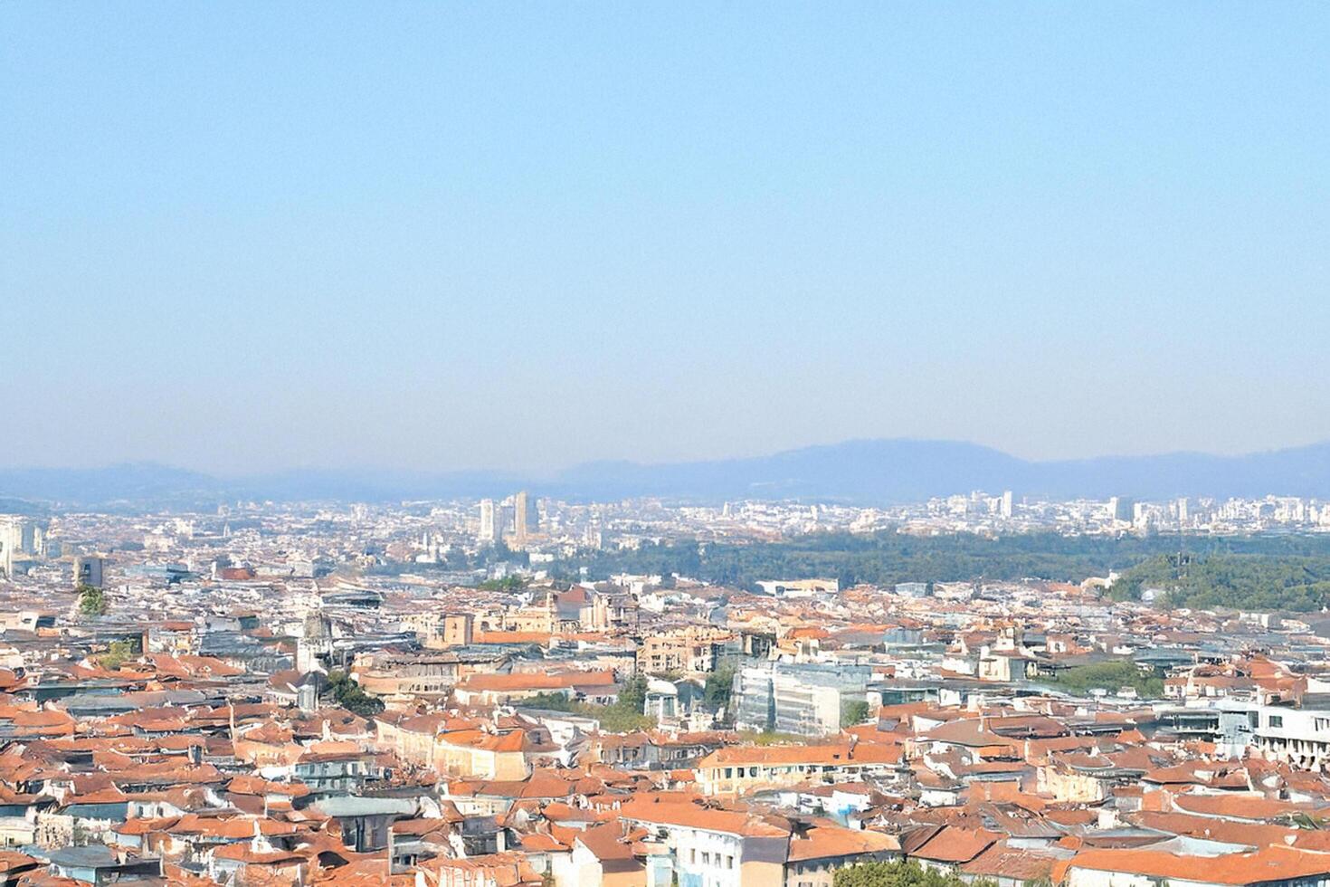 Cityscape panorama Elevated view of urban sprawl, mountains in background, travel postcard photo