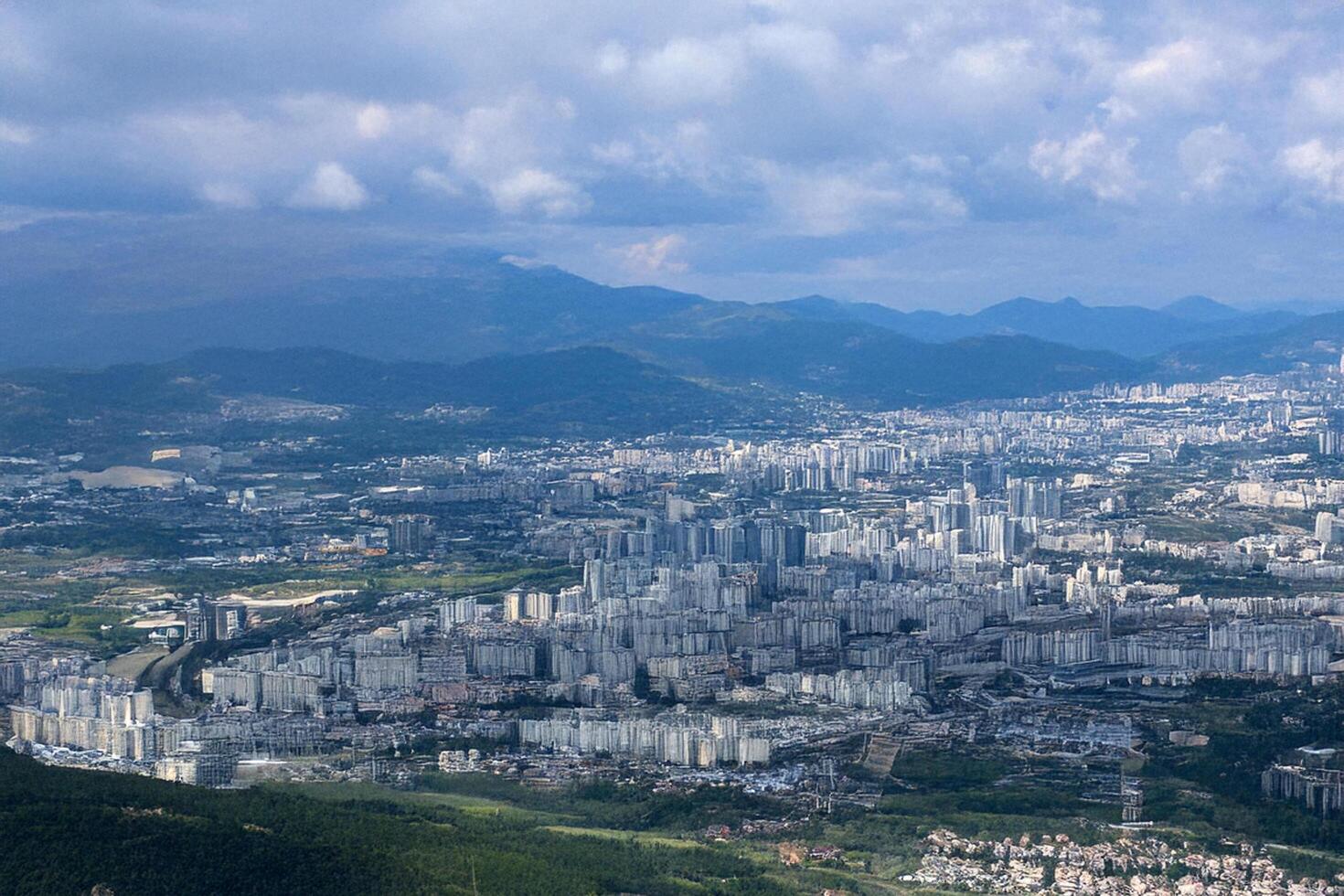 Mountaintop Cityscape View sprawling metropolis nestled in mountains photo