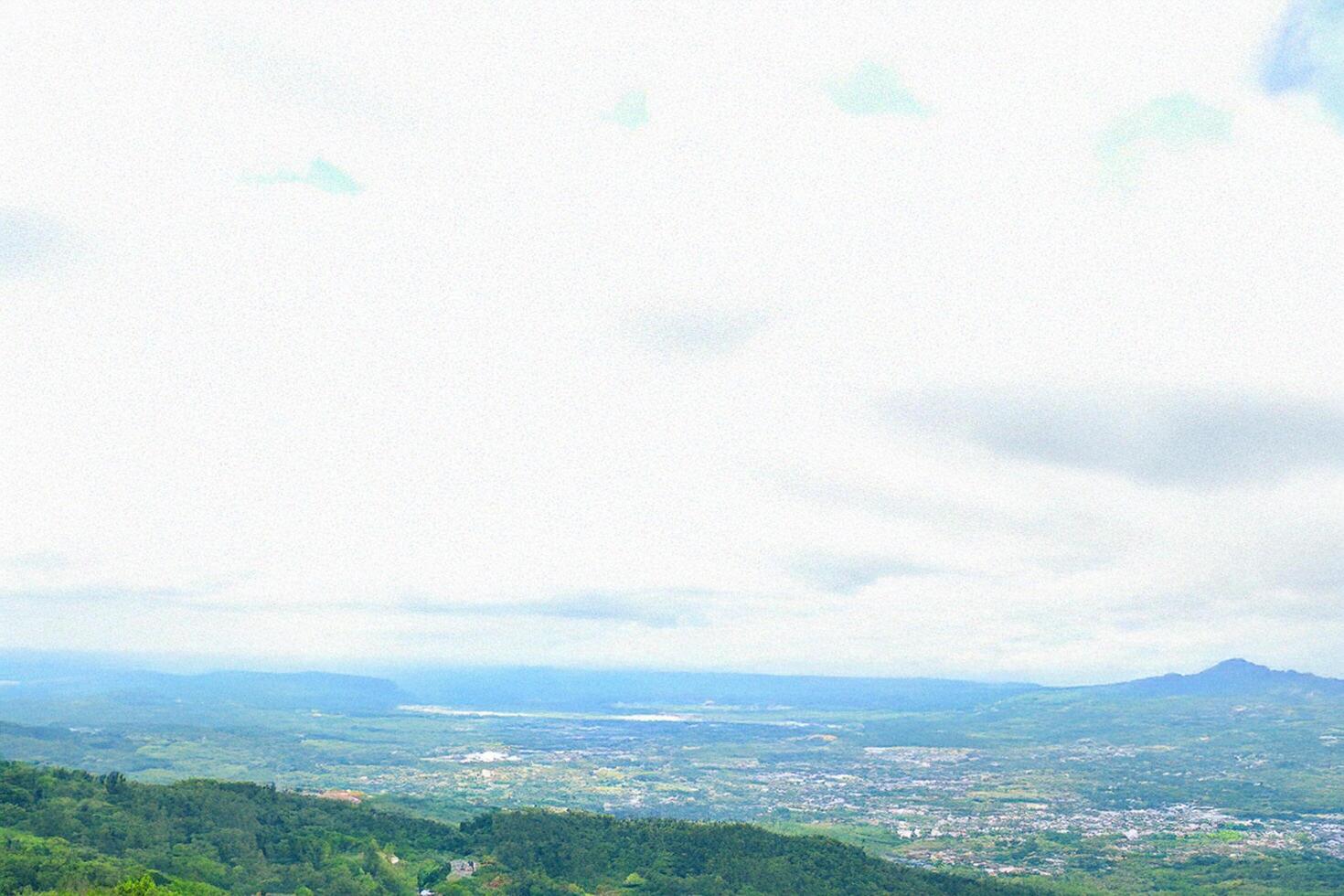 Mountaintop view serene valley panorama, cloudy sky photo