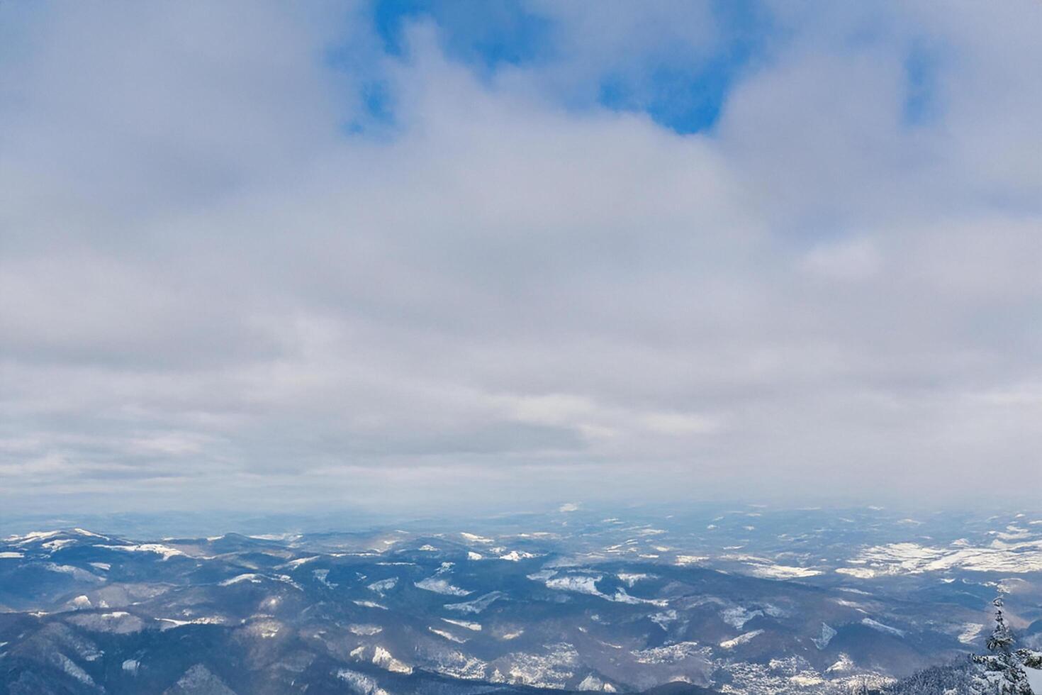 Snowy mountain vista, winter cloudscape, aerial view photo