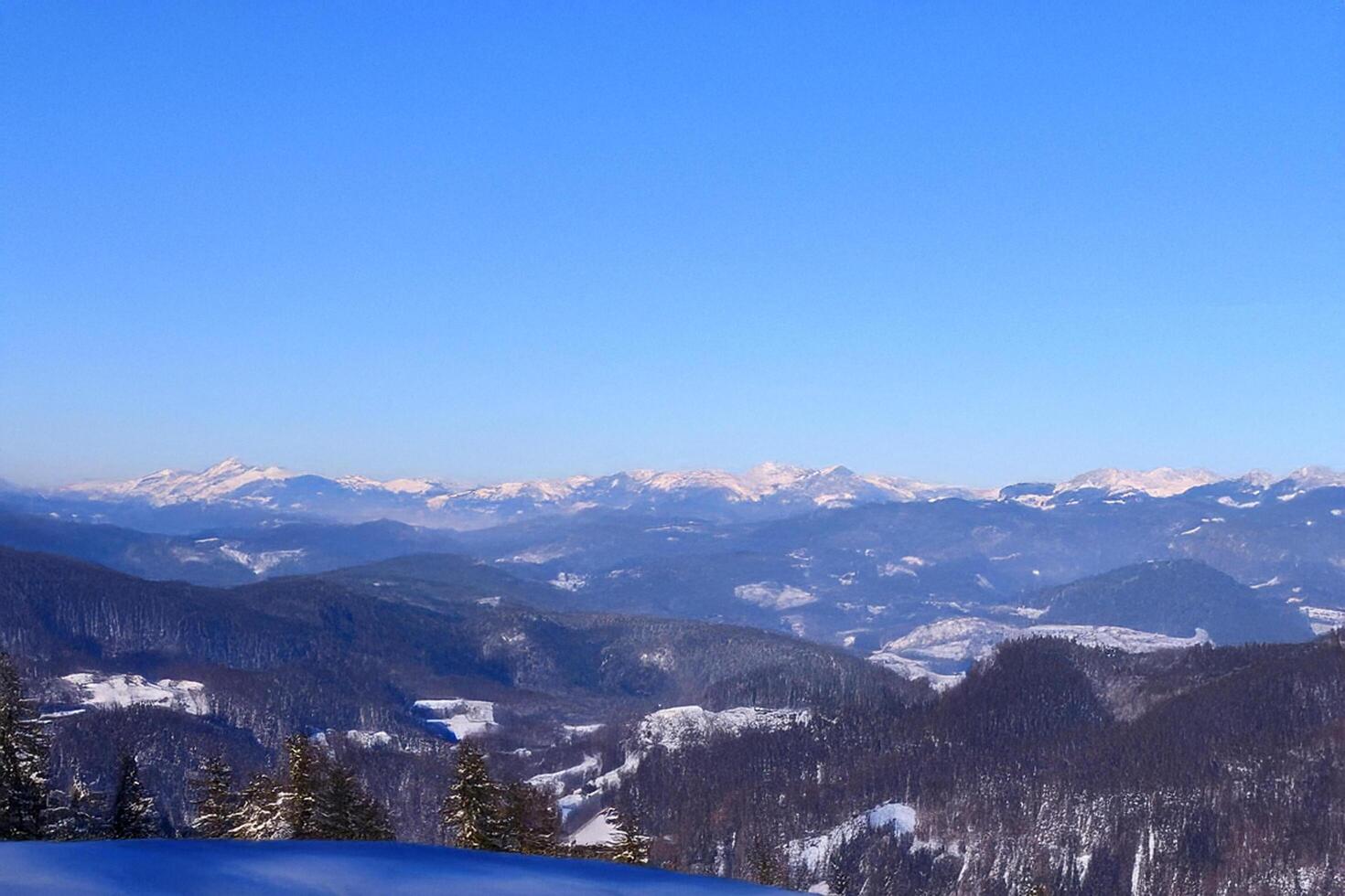 Snowy mountain vista, winter landscape, clear sky, scenic view, travel brochure photo