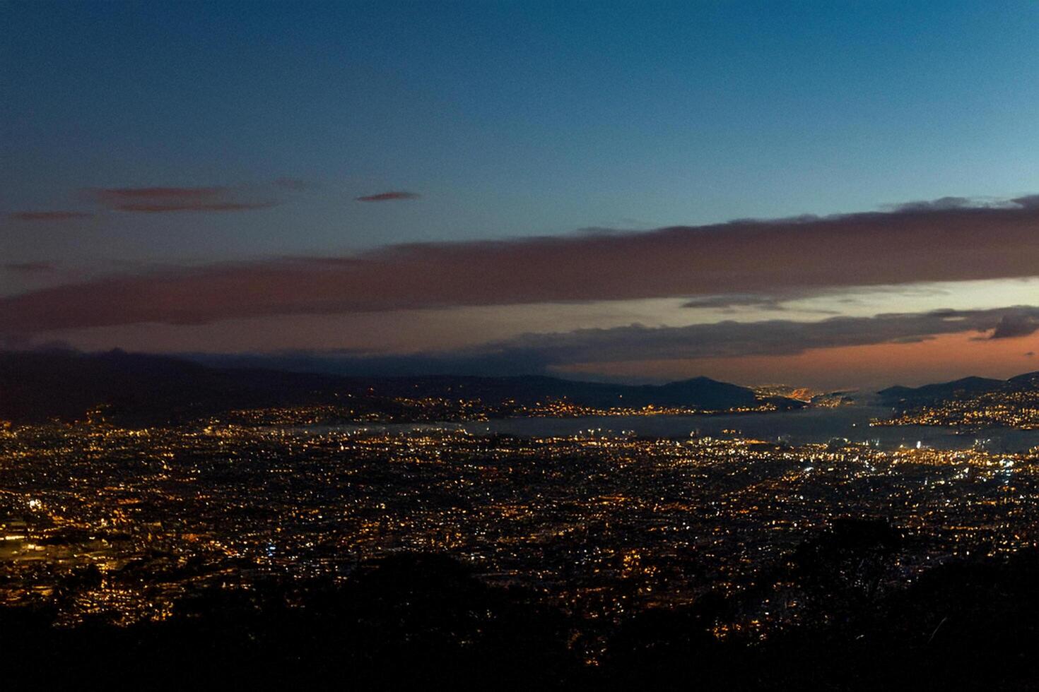 Night cityscape panorama, coastal view, twilight sky, urban lights photo