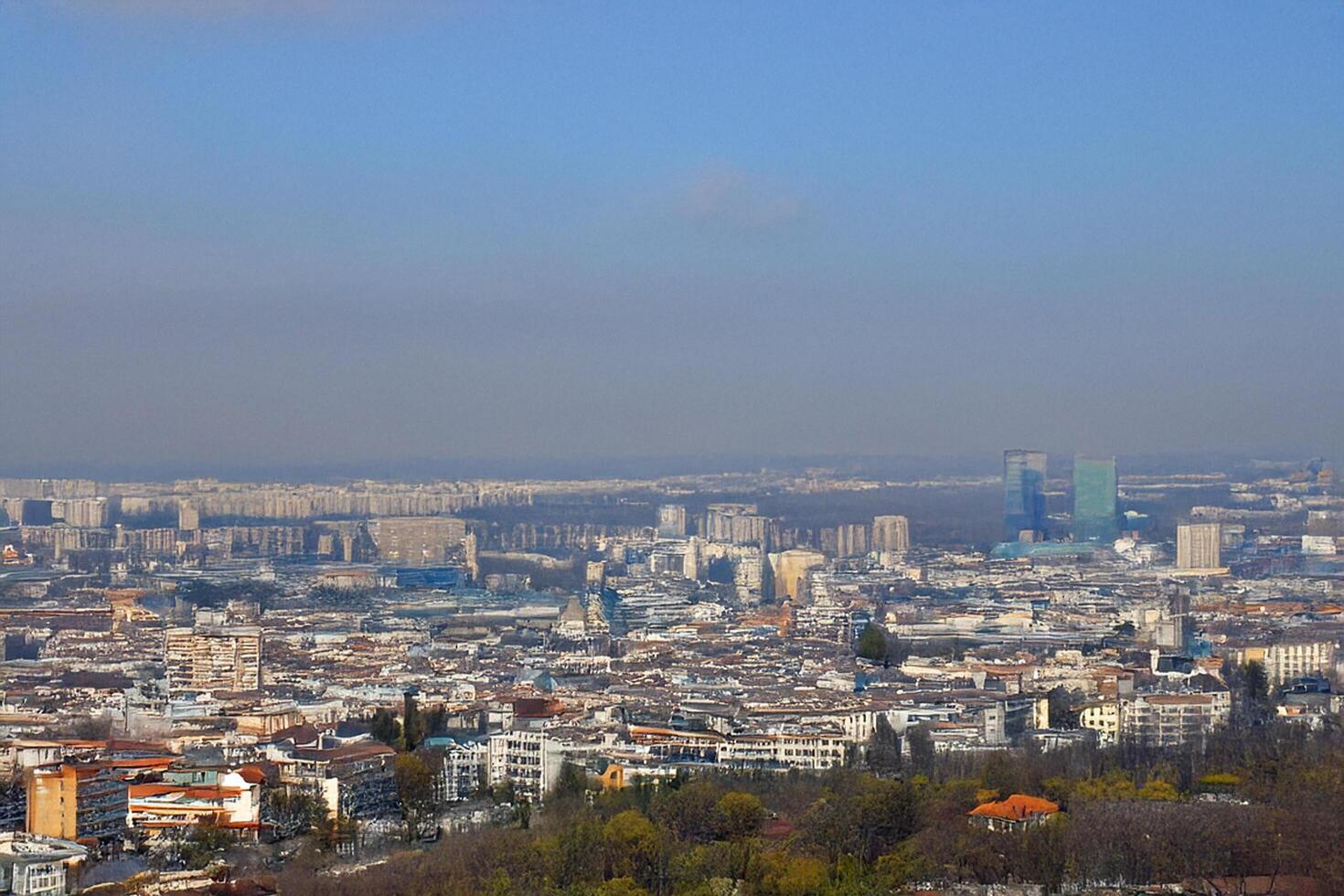 Hilltop panoramic city view, hazy skyline, urban sprawl, spring photo