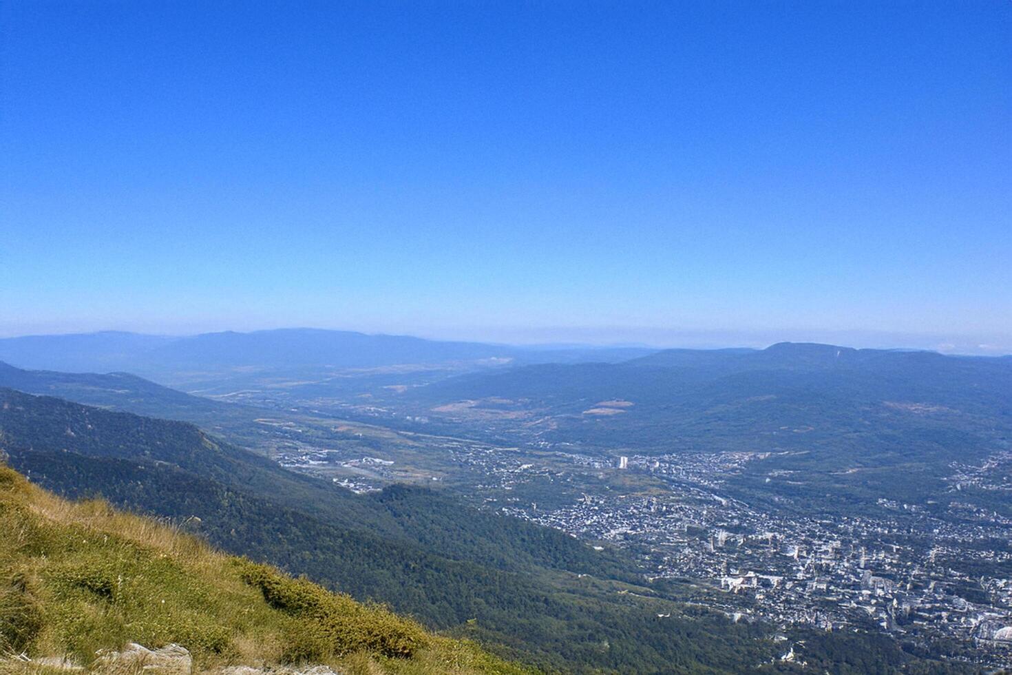Mountaintop view city valley panorama, clear sky photo