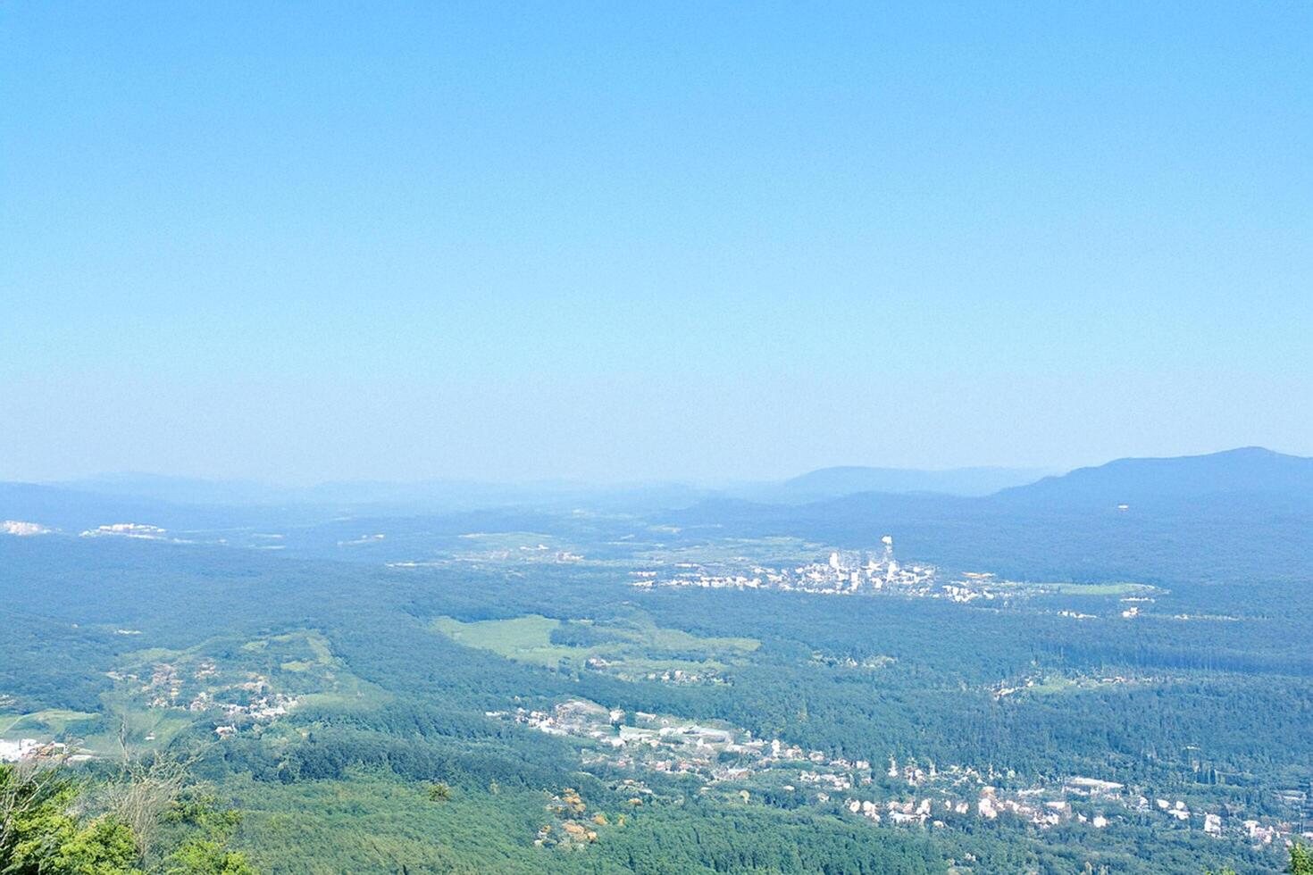 Mountaintop view Cityscape panorama, summer, distant buildings, travel postcard photo