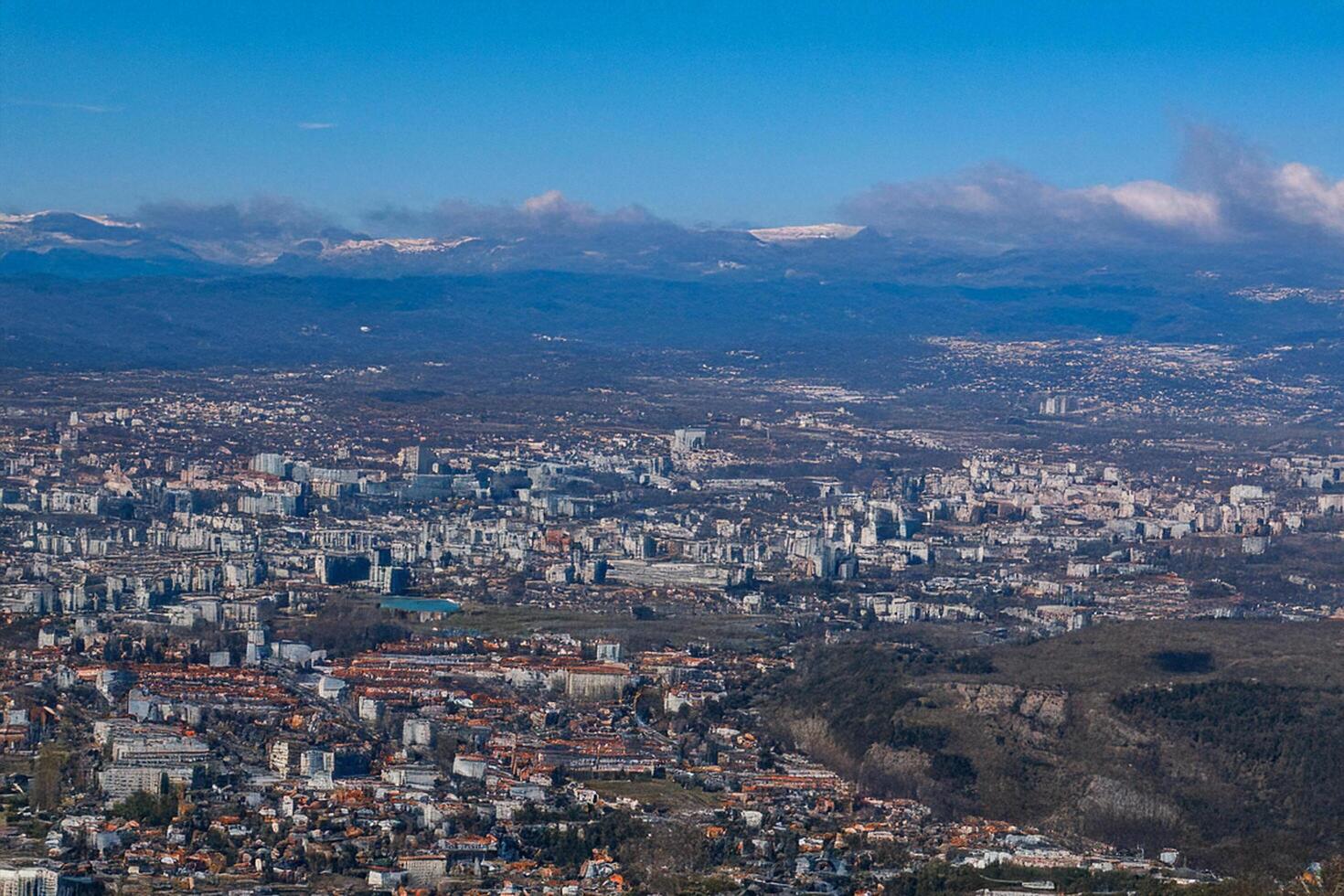 Cityscape aerial view, mountains background, sunny day, urban planning photo