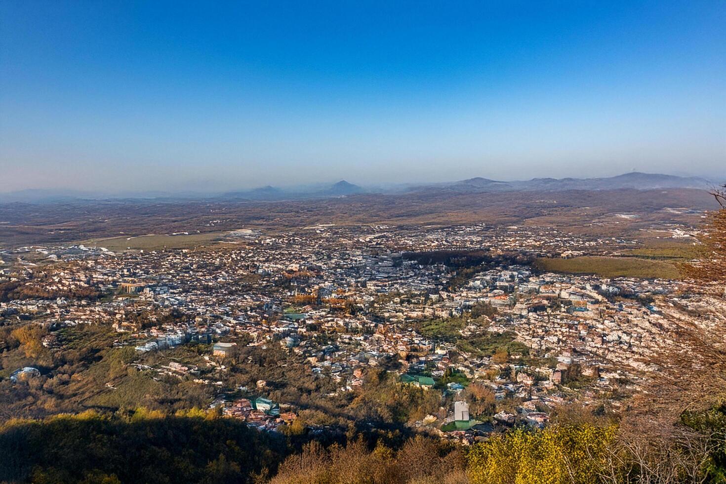 Panoramic autumn city view from mountaintop photo