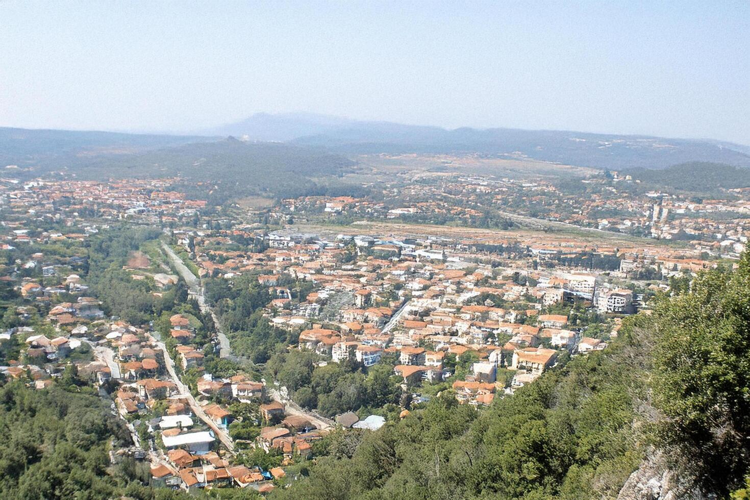 Hilltop view town, valley, mountains, summer photo