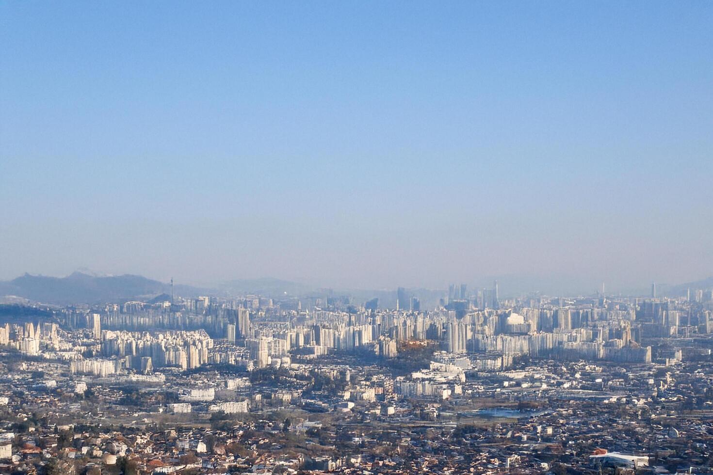 Hilltop Cityscape Panoramic view of urban sprawl, mountains, clear sky photo