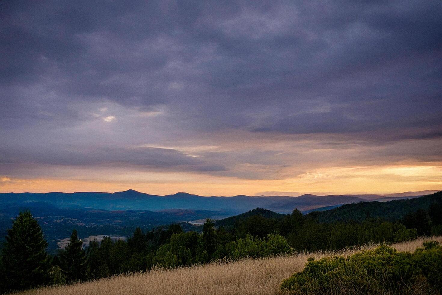 Sunset mountain landscape, dramatic sky, field, travel photo
