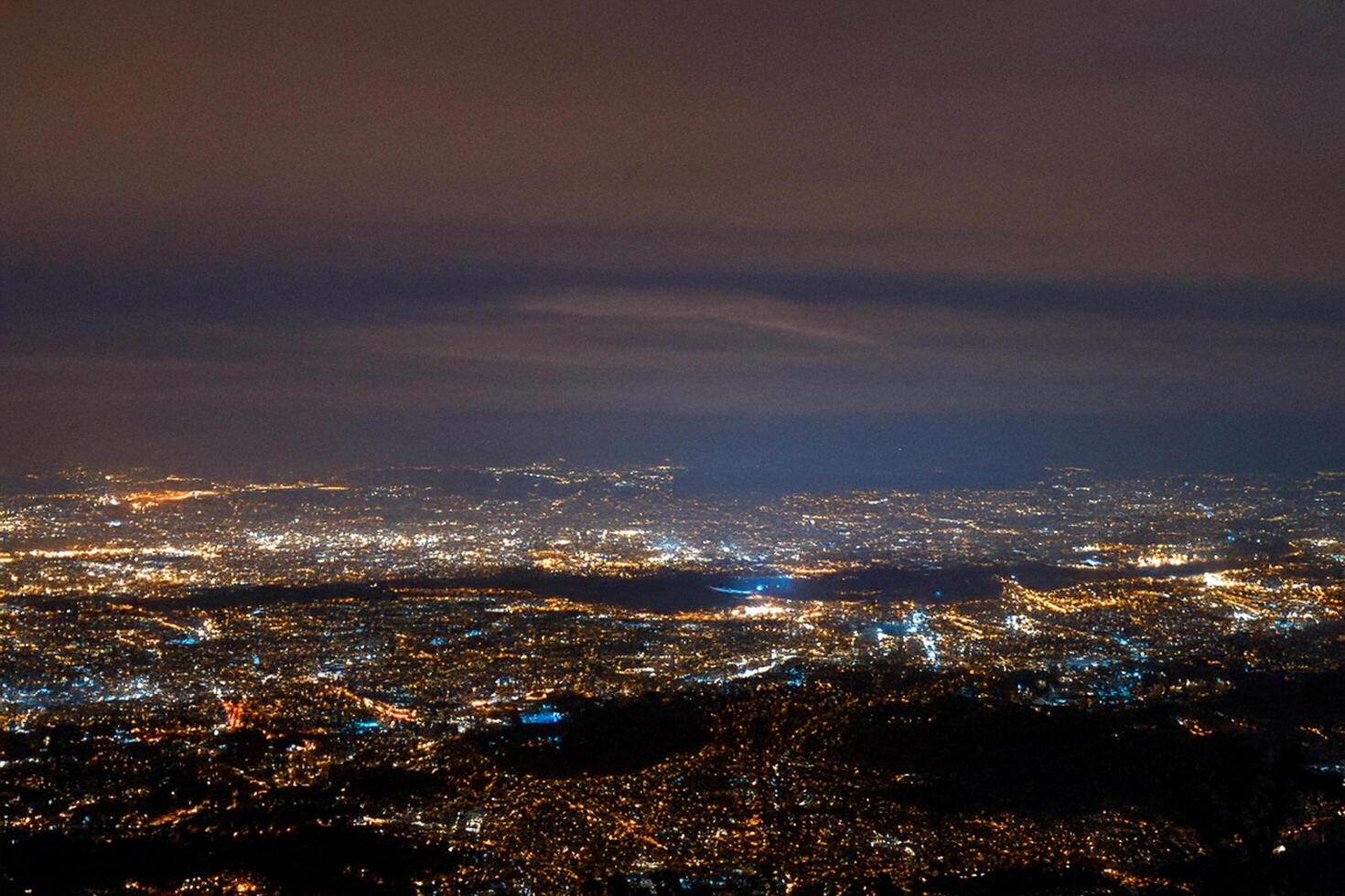 Night cityscape aerial view, city lights, mountaintop photo