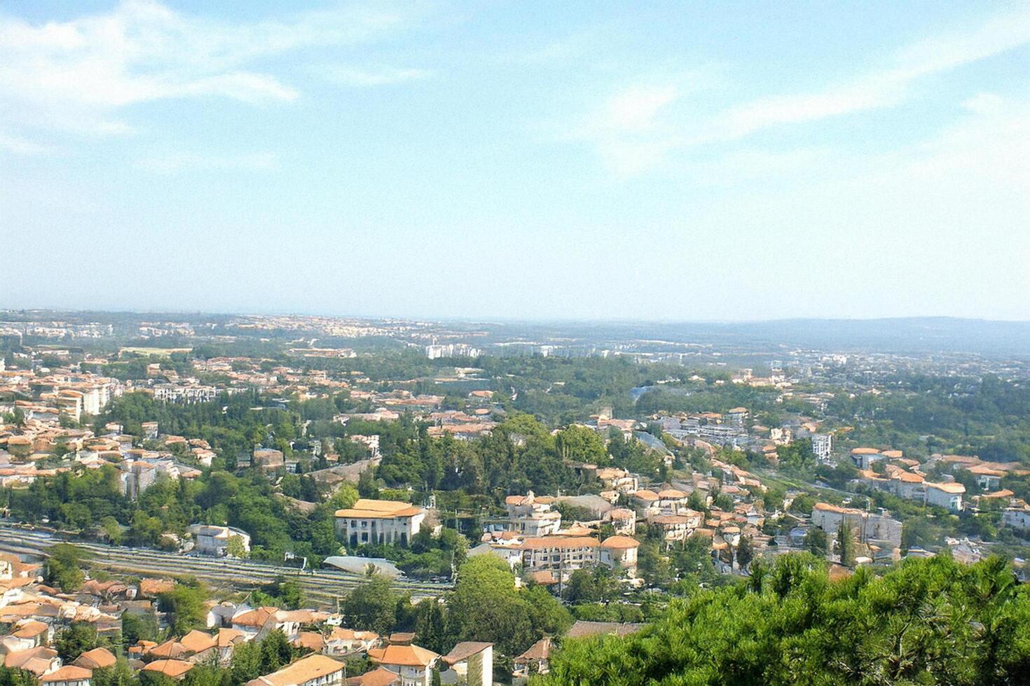 Hilltop view Cityscape panorama, sunny day, green hills photo