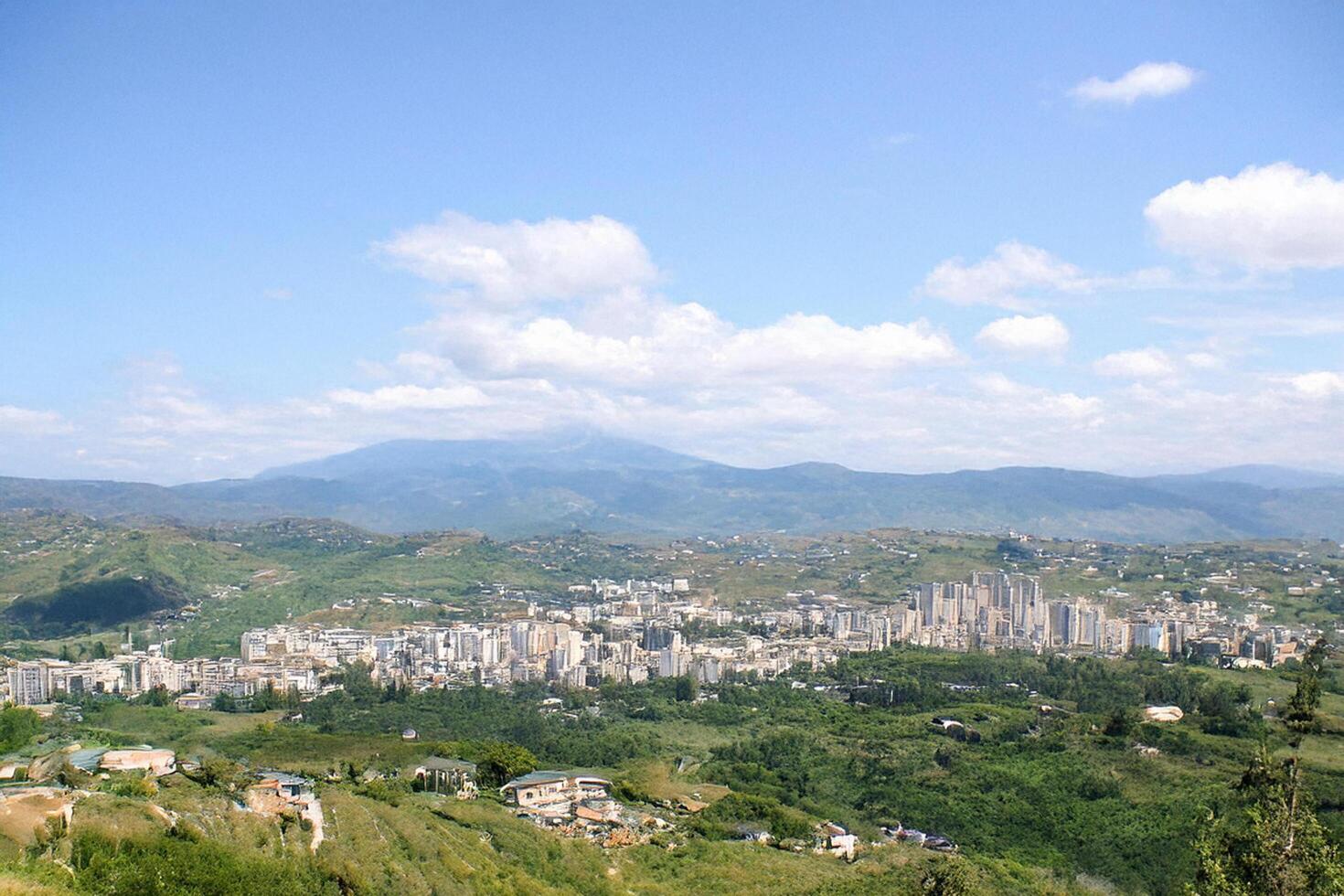 Hilltop Cityscape View Mediterranean mountain town panorama, background features distant mountains under a clear sky, ideal for travel brochures photo