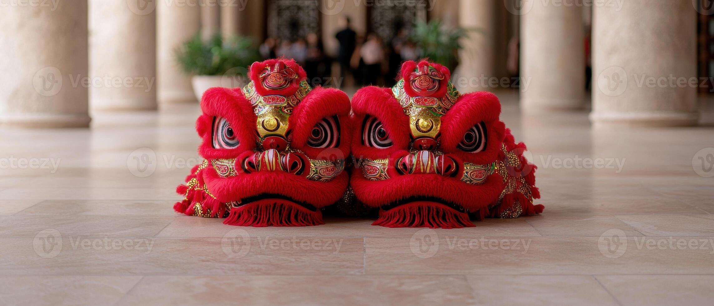 Two red lion dance heads sit on a marble floor photo