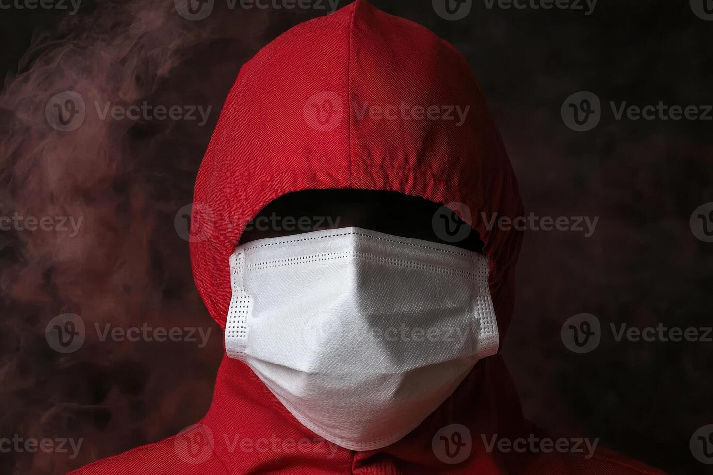 Person in red hooded jacket and white face mask photo