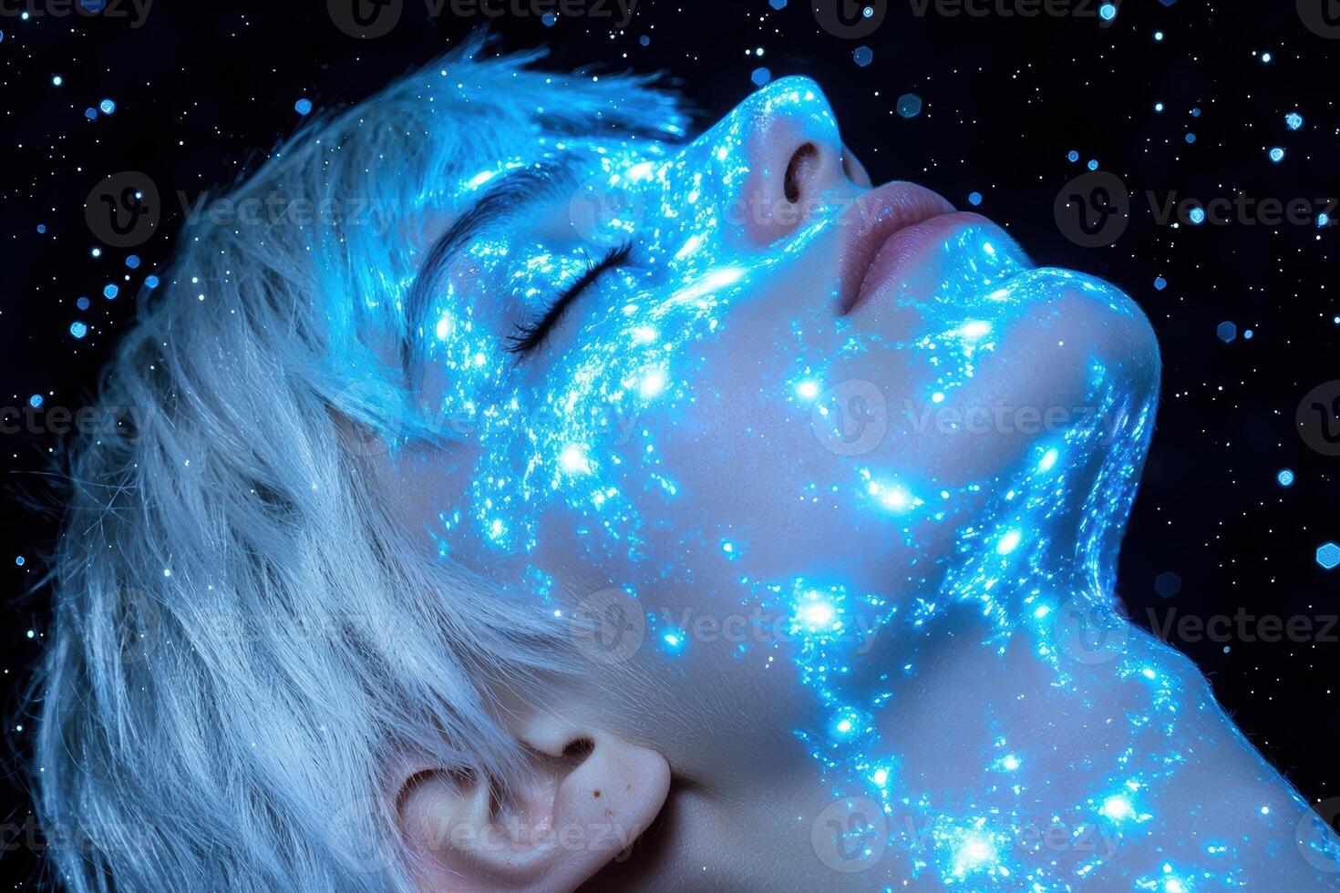 Closeup of a womans face with glowing blue paint, resembling a nebula or galaxy photo