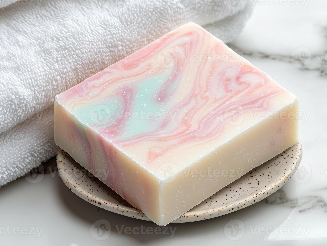 Spa soap bar on a soap dish next to a towel photo