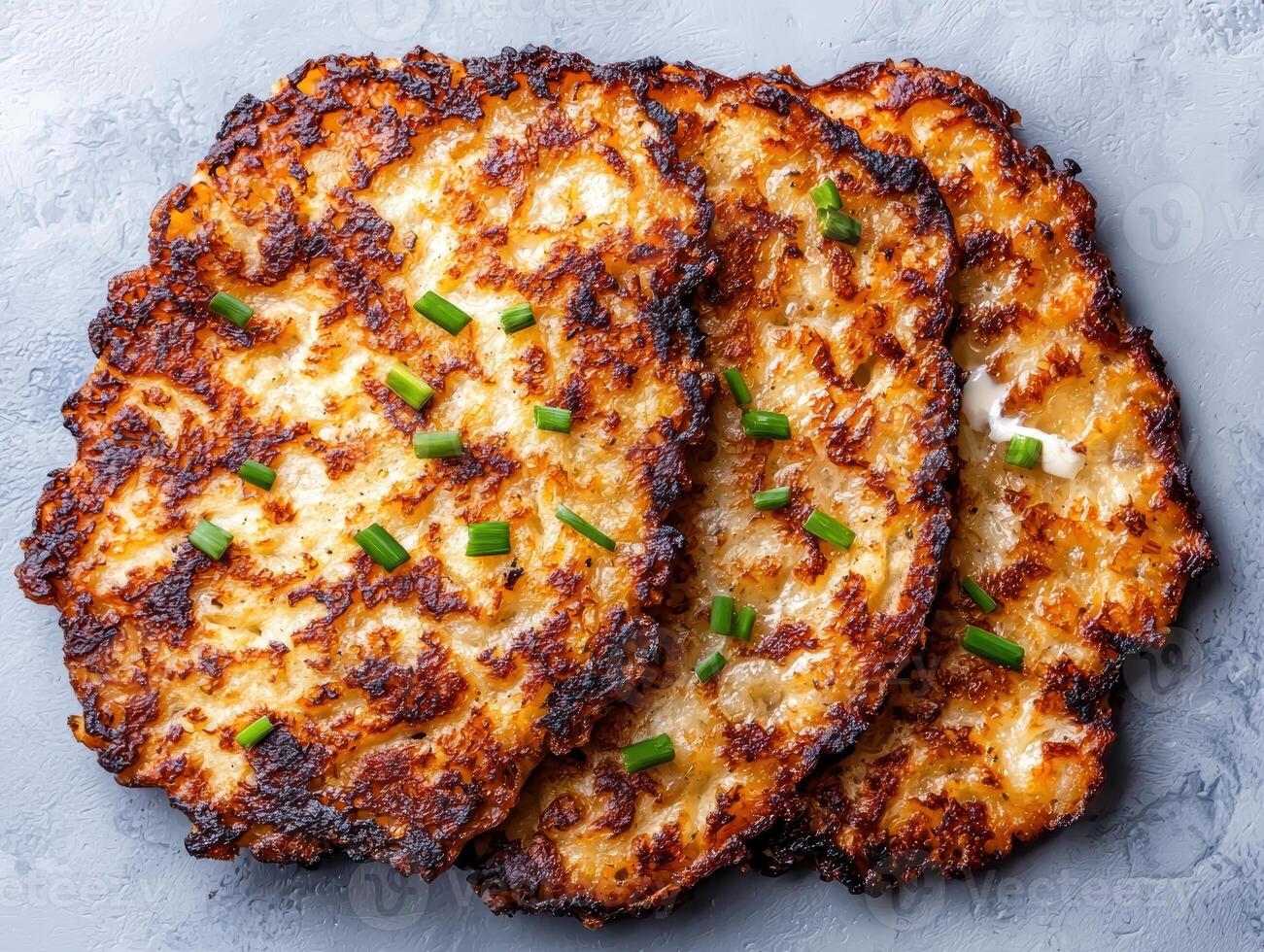 Crispy potato pancakes with fresh chives photo