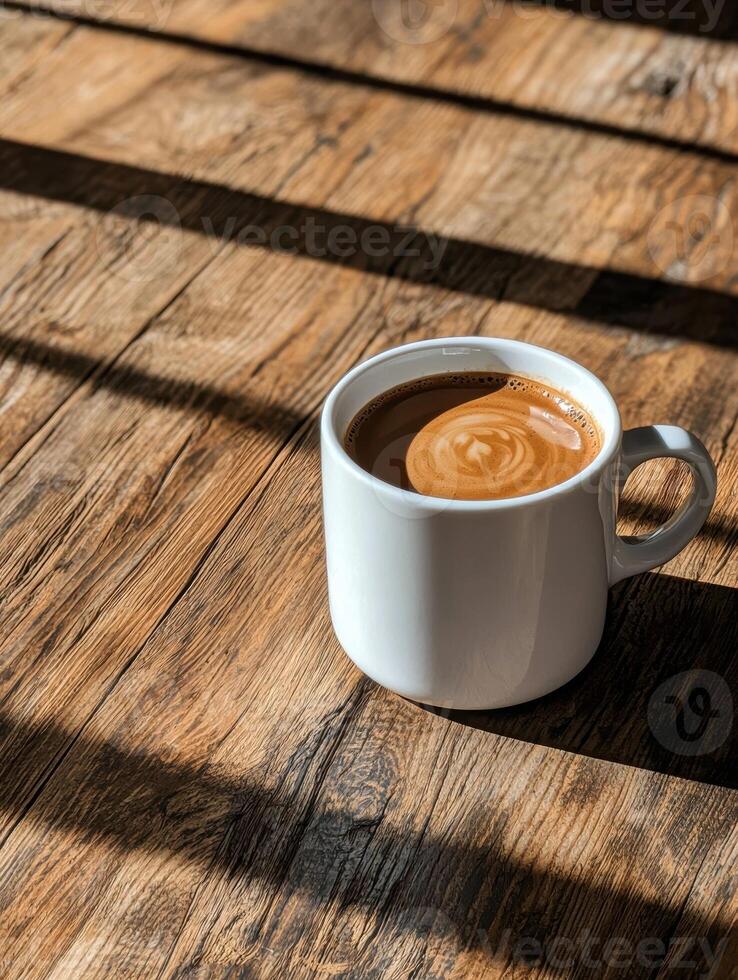 Morning coffee in a white mug on a rustic wooden table photo