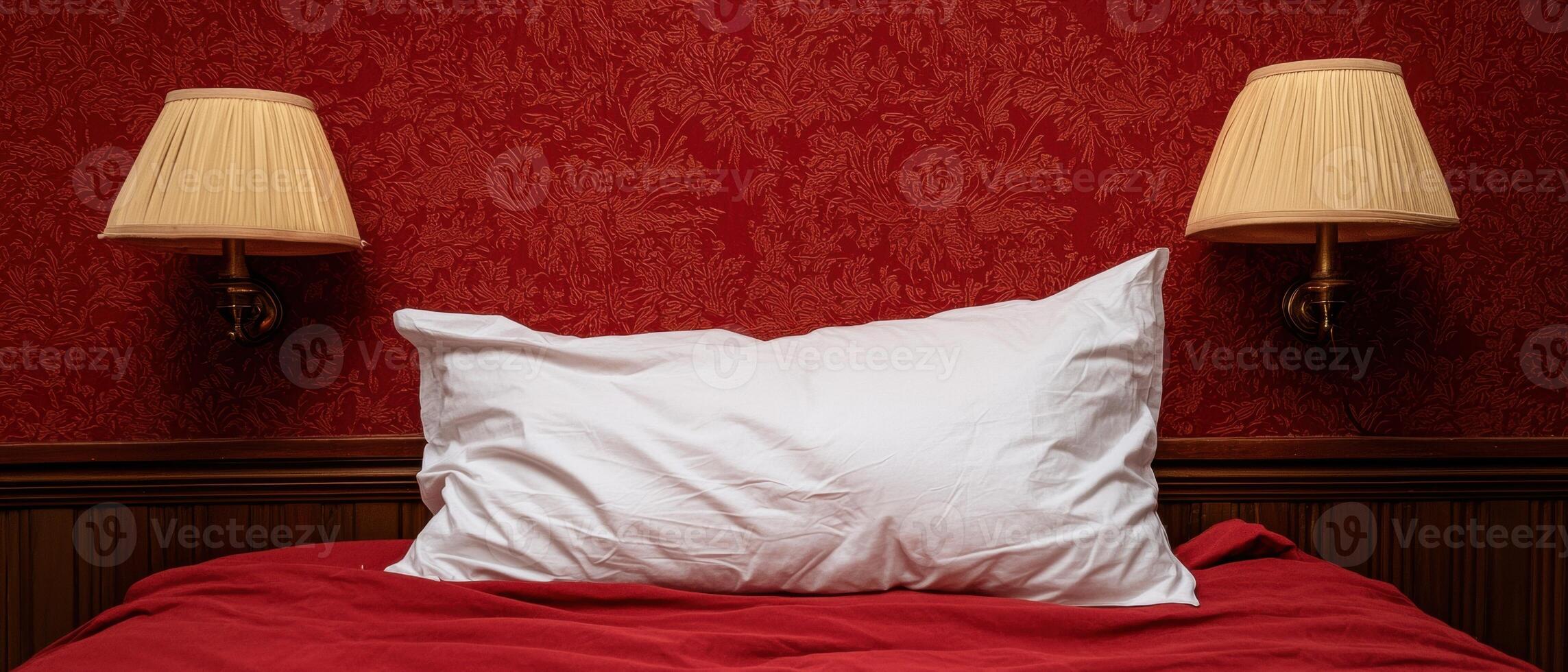 Red bedroom with white pillow and lamps photo