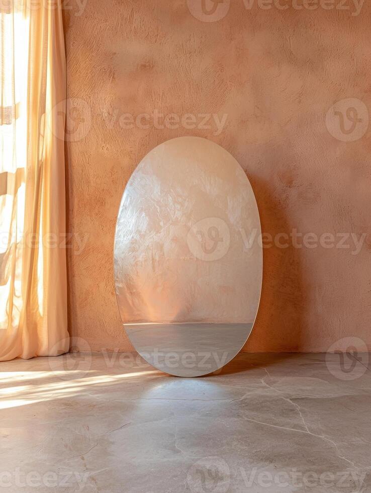 Oval mirror leaning against a textured wall photo