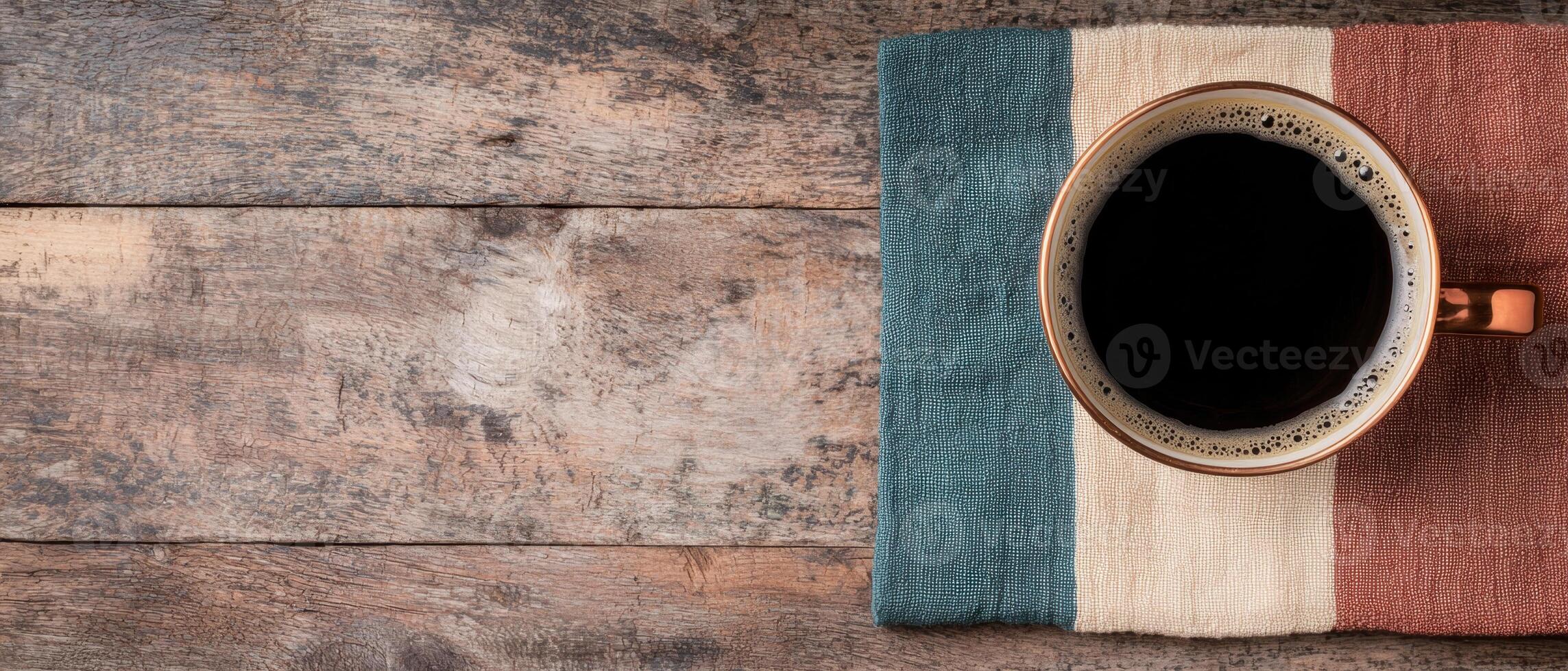 Top view of a cup of coffee on a rustic wooden table photo