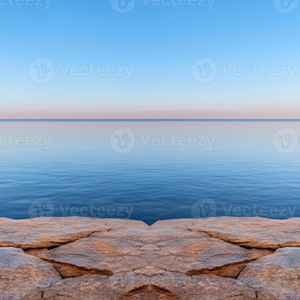 Tranquil ocean view from a rocky shore at sunset photo
