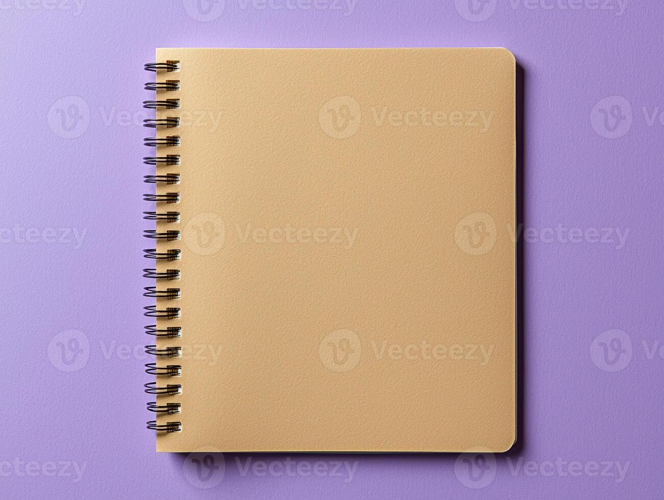 Blank spiral notebook on purple background photo