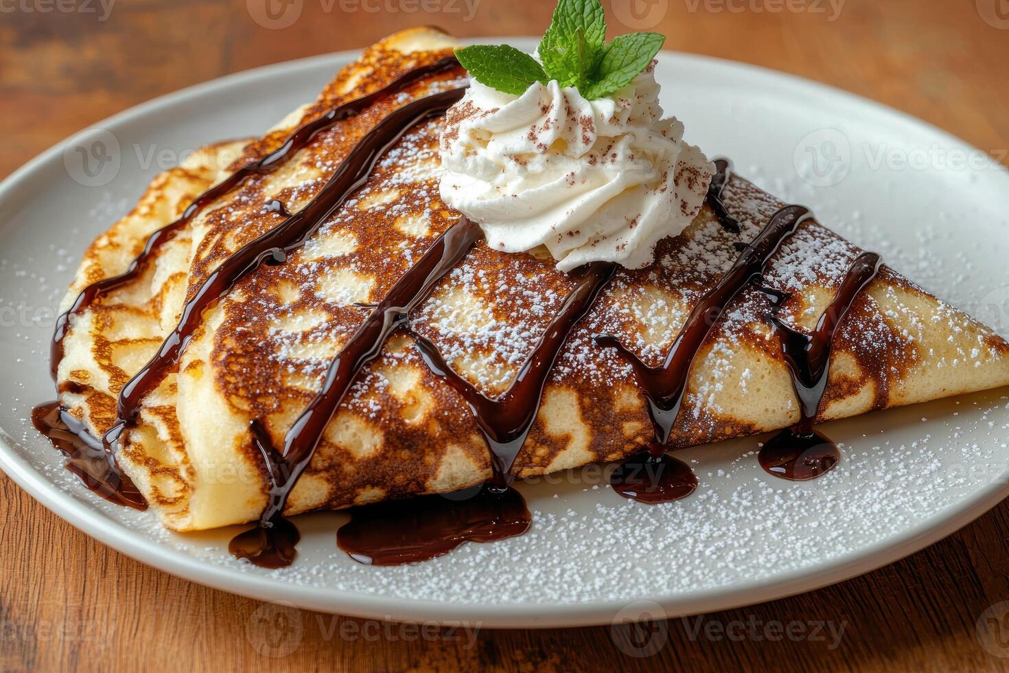 Delicious crepe with chocolate sauce and whipped cream. photo