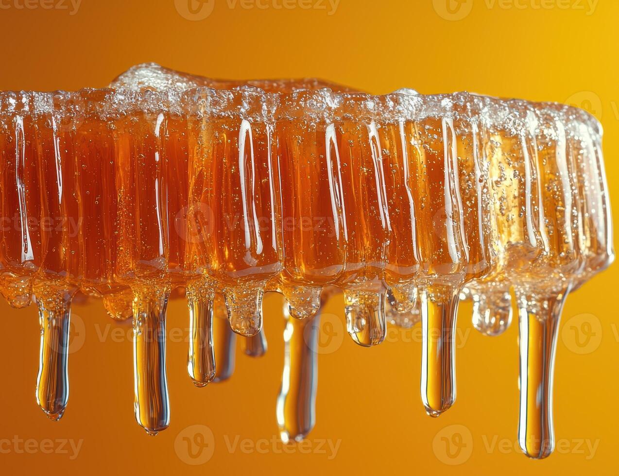 Close up of honey dripping from a honeycomb photo