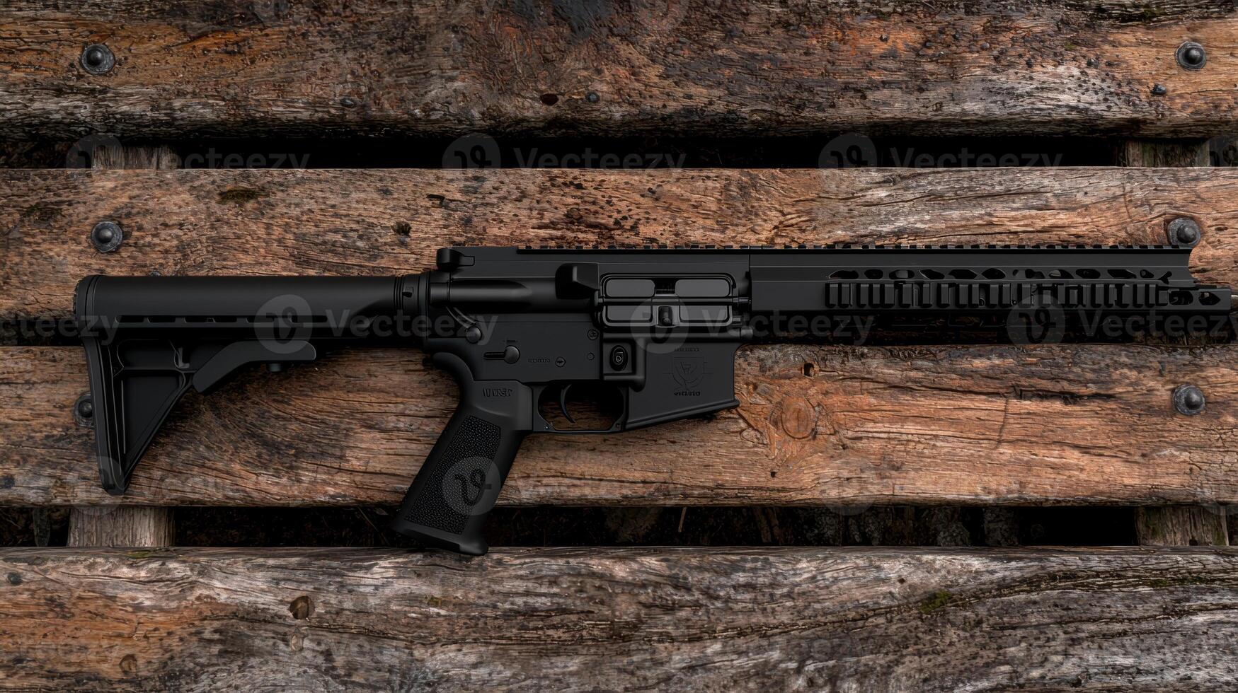 A black rifle on wooden background photo