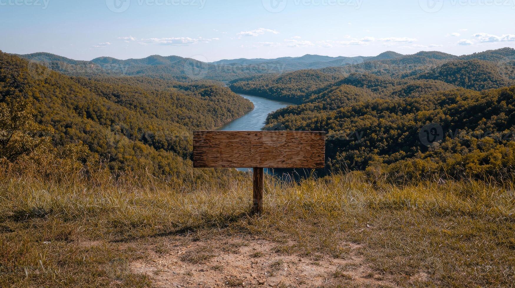 Blank wooden sign overlooking a scenic river valley photo