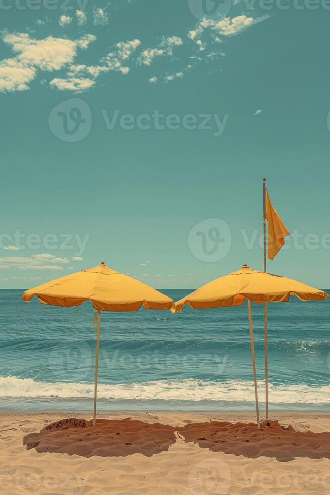 Two yellow umbrellas provide shade on a serene beach under a bright blue sky. photo