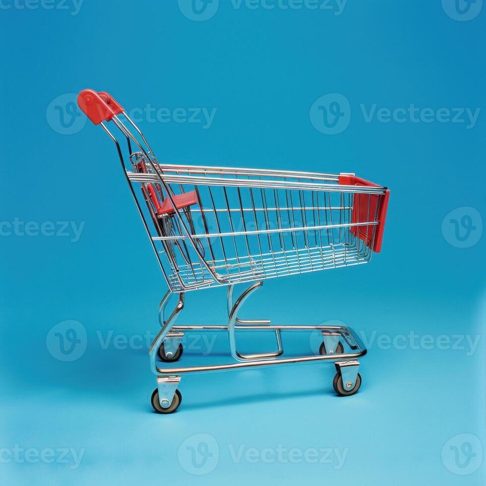 Empty shopping cart against a bright blue background, highlighting its sleek metallic design. photo