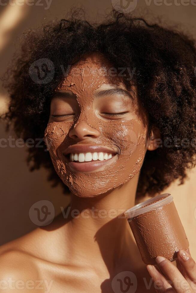 Joyful young African American woman with a clay face mask basking in sunlight. photo