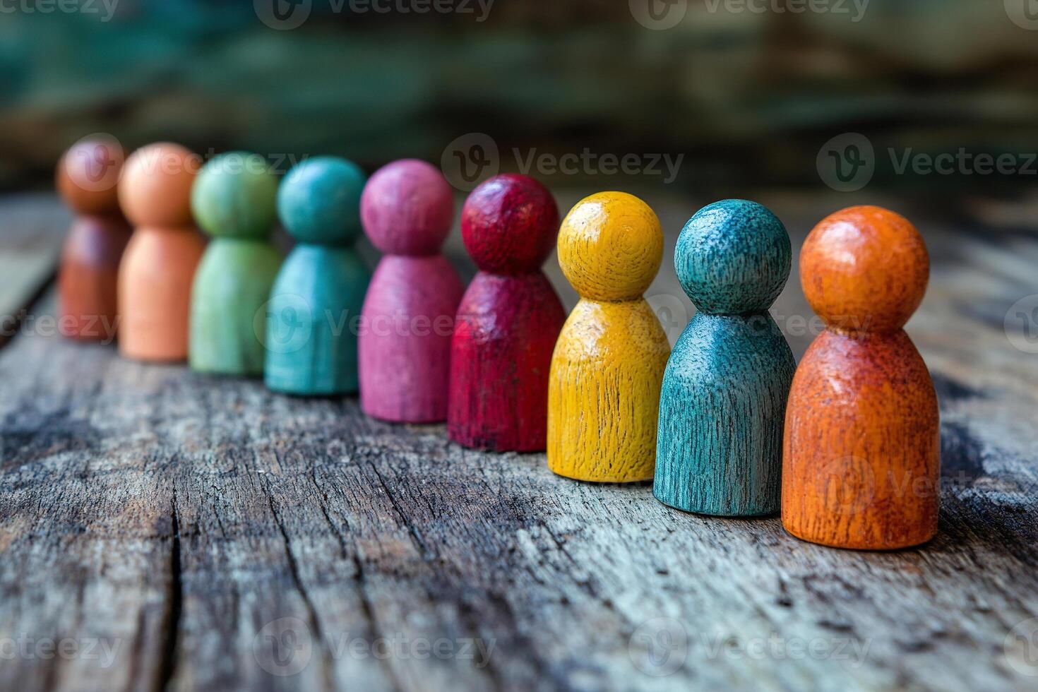 Wooden figures of different colors on a wooden surface. The concept of a team game, business, recruitment. photo