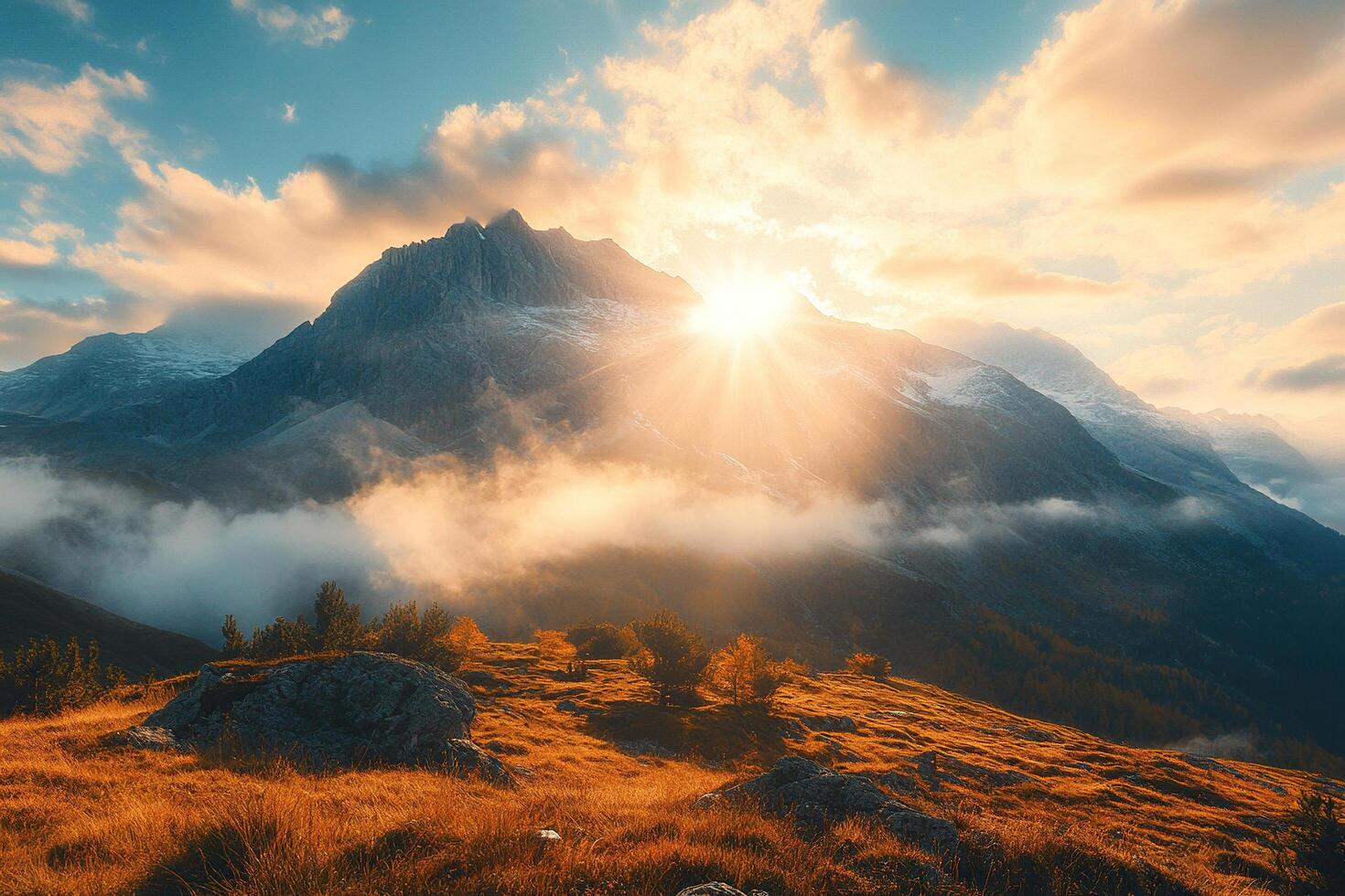 View of sunset over the mountains. The setting sun casts a warm golden light, blue cloudy sky. photo