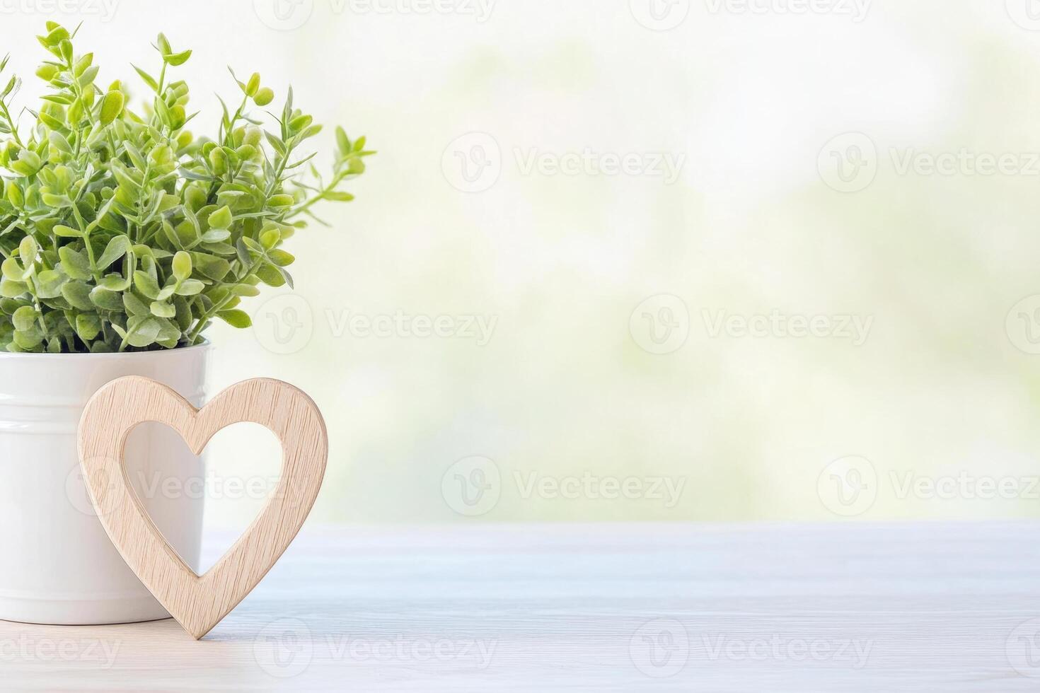 Photo frame of heart shape for mockup design on light table background