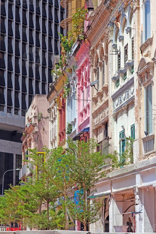 Colorful historic facade with modern high-rise contrast in Kuala Lumpur photo