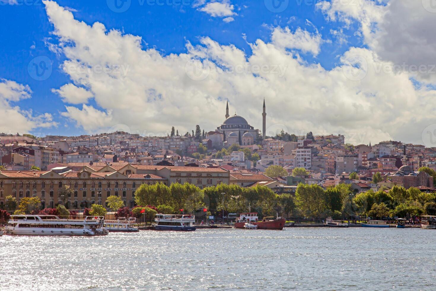 Sultan Ahmed Mosque and cityscape from Ataturk Bridge with water and boats photo
