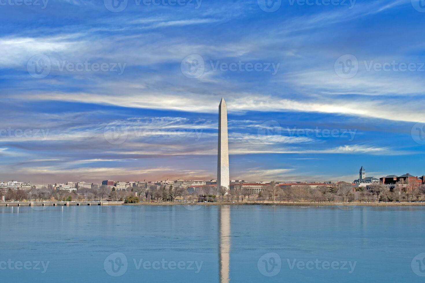 Stunning view of the Washington Monument reflecting in the Tidal Basin under dramatic skies photo