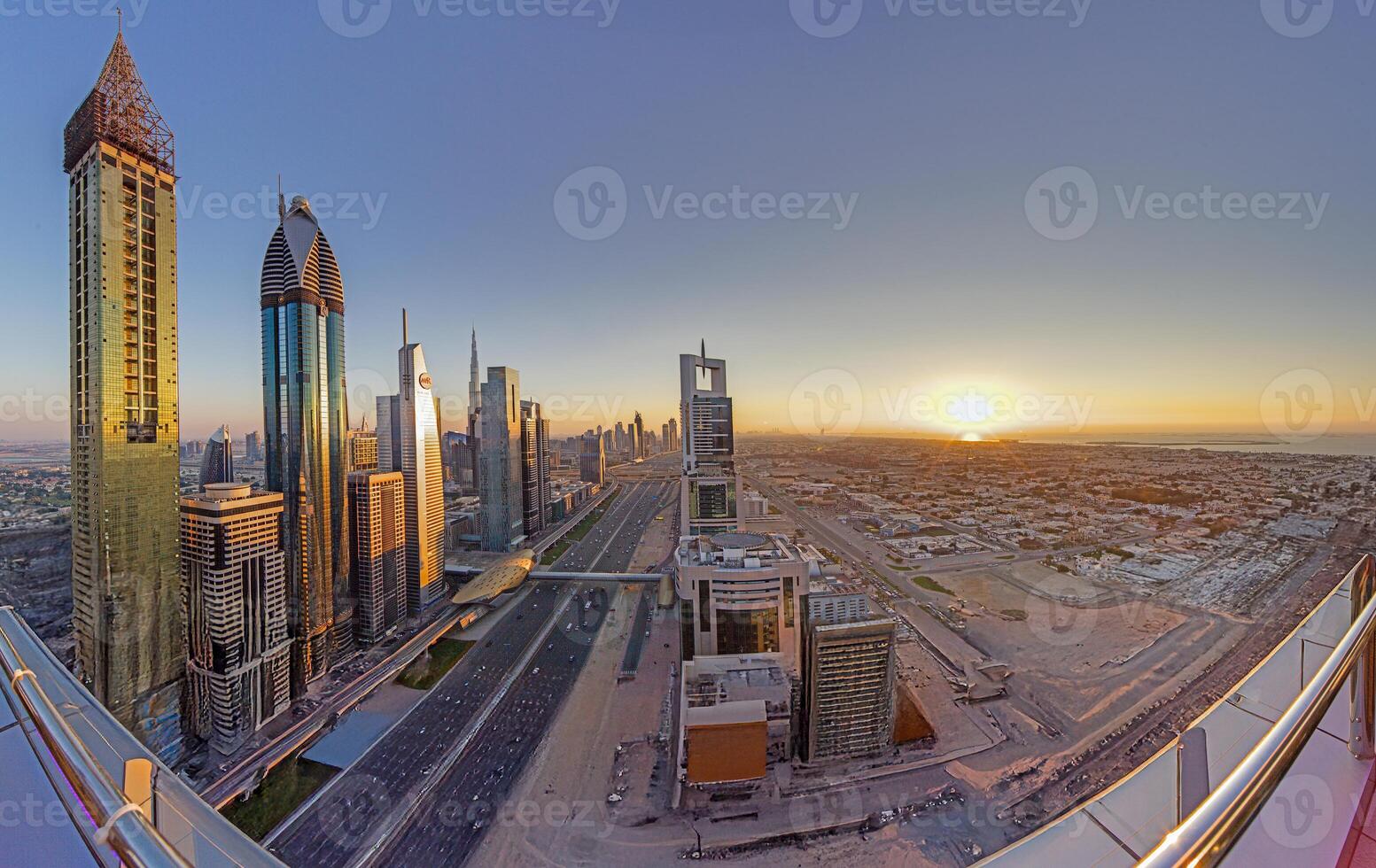 Sheikh Zayed Road skyline in Dubai with sunset and skyscrapers in 2015 photo
