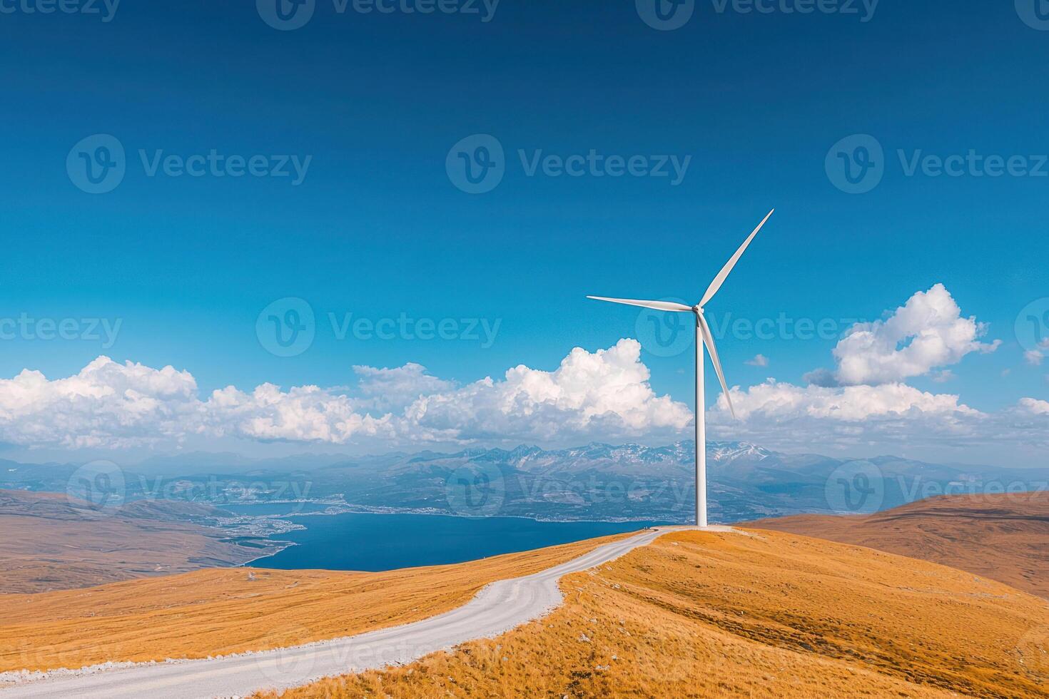 A serene landscape featuring a wind turbine against a blue sky and rolling hills. photo