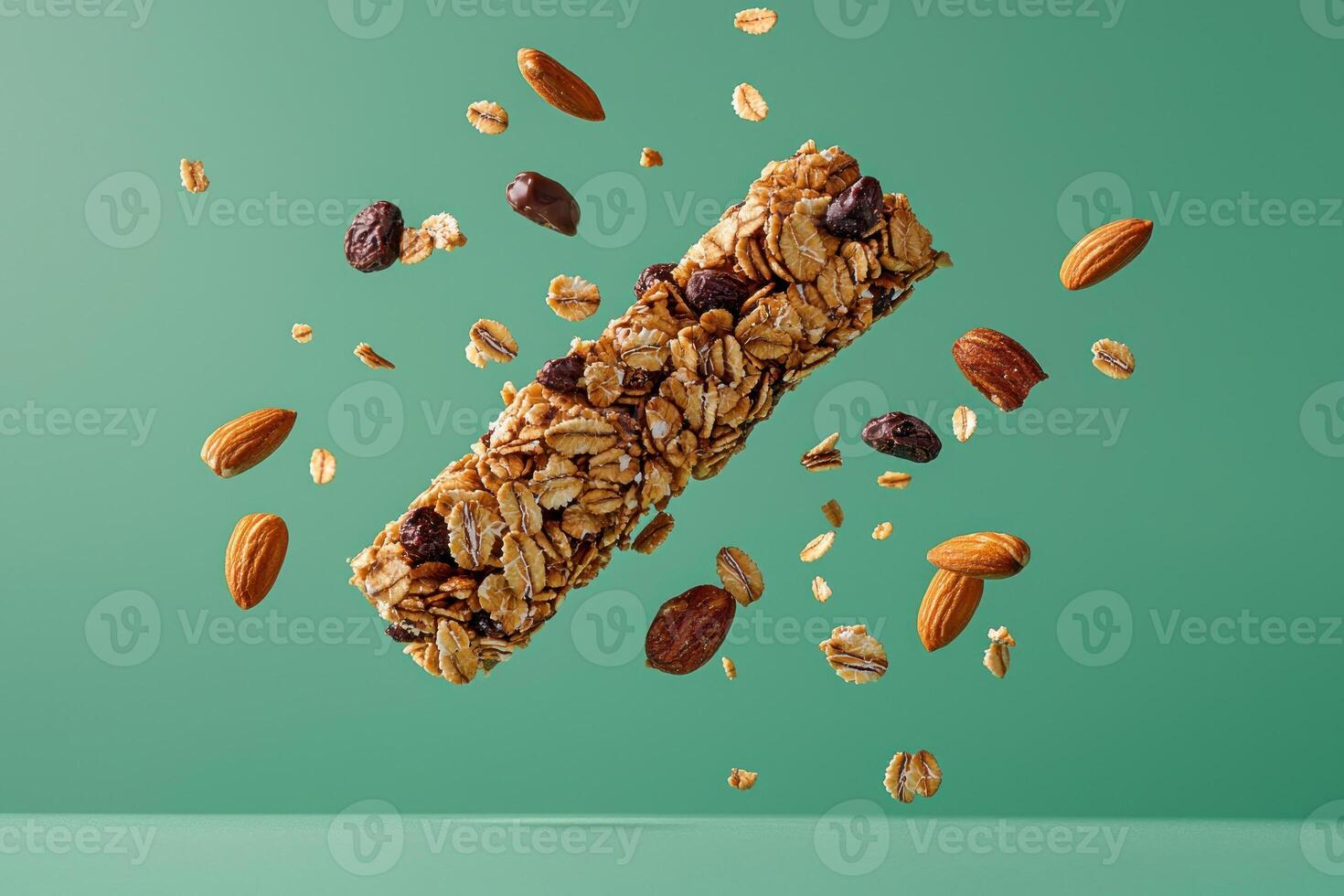 Healthy granola bar with nuts and fruits floating against a green background. photo